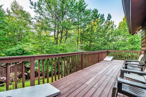a wooden deck with chairs and trees on it at NEW HOT TUB! Secluded 3 Bed Cabin in Pigeon Forge in Pigeon Forge