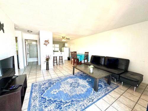 a living room with a couch and a table at MaiLan Hale in Kailua-Kona