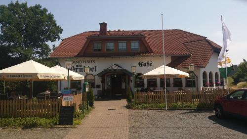 a building with umbrellas in front of a building at Landhaus am Brubbel in Wallenborn