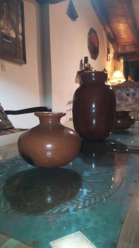 two brown vases sitting on top of a table at Cabañas "Rancho La Mesa" in Pátzcuaro