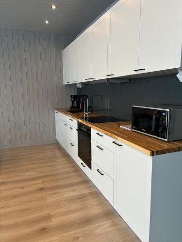 a kitchen with white cabinets and a counter top at Toppvillan - Ski In - Ski Out - 200 m till toppen och cykelleder in Järvsö