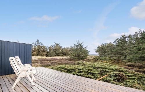 a white chair sitting on top of a wooden deck at Awesome Home In Brovst With Wifi in Brovst