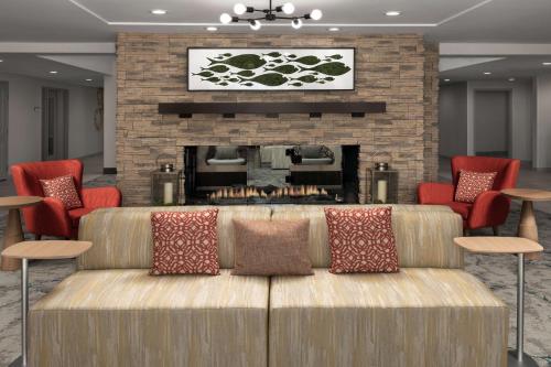 a living room with a couch in front of a fireplace at Hilton Garden Inn Los Angeles Marina Del Rey in Los Angeles