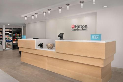 a store with a reception counter with a million garden inn sign at Hilton Garden Inn Los Angeles Marina Del Rey in Los Angeles