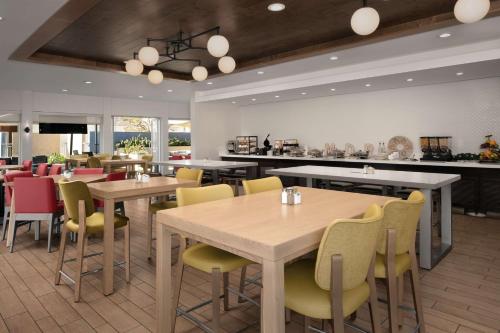 a restaurant with tables and chairs and a counter at Hilton Garden Inn Los Angeles Marina Del Rey in Los Angeles
