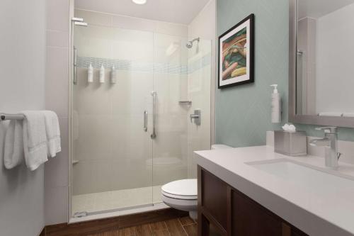 a bathroom with a shower with a toilet and a sink at Hilton Garden Inn Los Angeles Marina Del Rey in Los Angeles