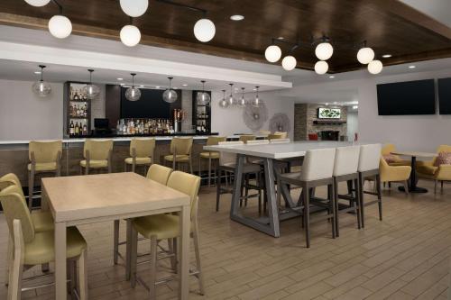 a restaurant with tables and chairs and a bar at Hilton Garden Inn Los Angeles Marina Del Rey in Los Angeles