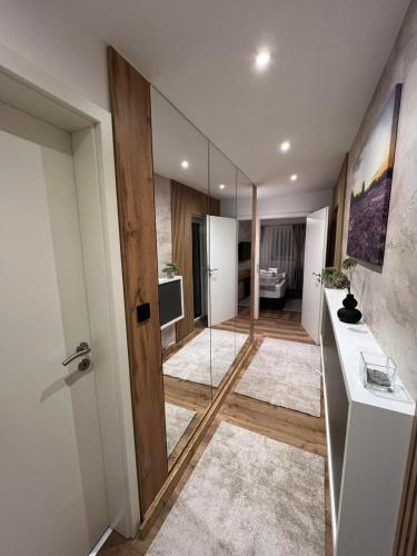 a bathroom with a glass door and a room with a sink at Ferienwohnung E in Soltau
