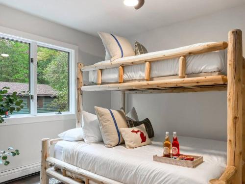 a bedroom with two bunk beds in a room at Lakeside Oasis in Kalkaska