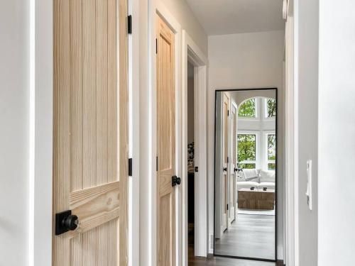 a hallway with a door and a mirror at Lakeside Oasis in Kalkaska