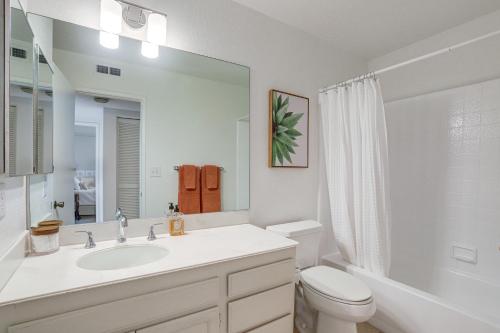a white bathroom with a sink and a toilet at Palm Desert Condo with Patio and Golf Course Views in Palm Desert