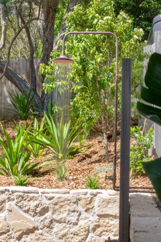 a garden with a light on a stone wall at Beachstead in Gerroa