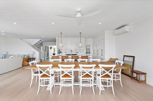 a kitchen and dining room with a table and chairs at Beachstead in Gerroa
