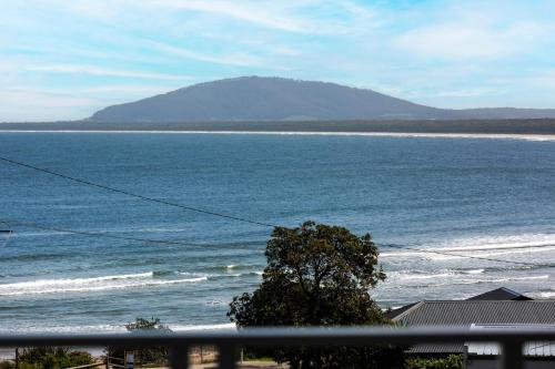 a view of the ocean with a mountain in the background at Beachstead in Gerroa