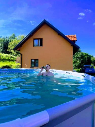 a man taking a picture in a swimming pool at RAJ NA TARI in Užice