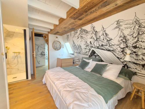 a bedroom with a bed with a mountain mural on the wall at A l'orée des bois in Les Angles