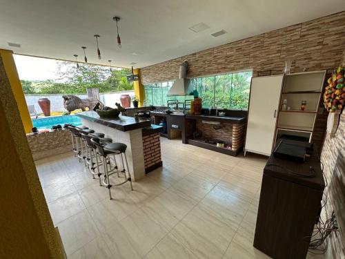 a kitchen with a counter and some stools in it at Casa Amarela in Paranoá