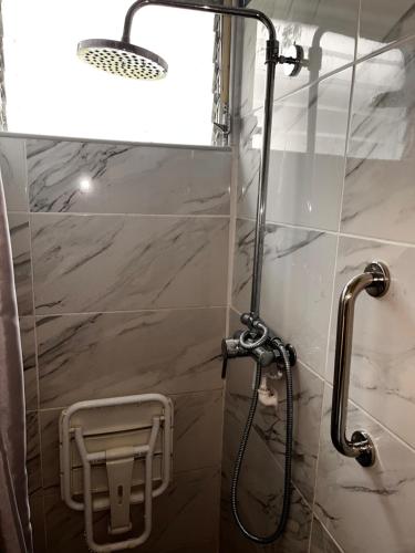 a shower with a glass door in a bathroom at Cheerful 3 bedroom home with stunning views in Quartier la Fleury Guiné