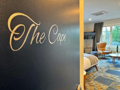 a hotel room with a sign that reads the cape at Artisan Suites on Bowen in Bowen Island