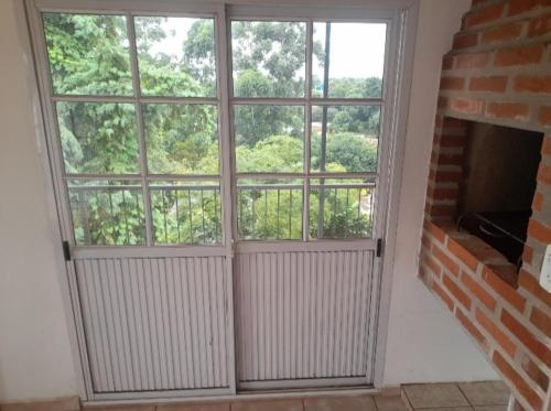 a large window in a room with a brick fireplace at Residencial GM in San Vicente