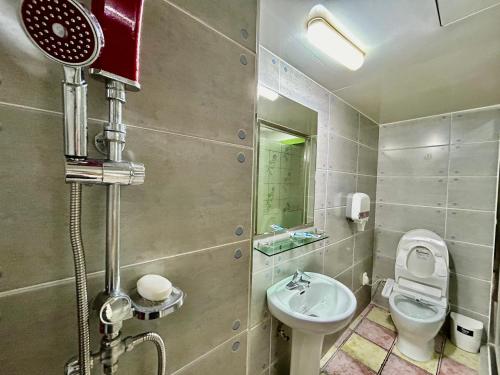 a bathroom with a toilet and a sink at Two motel in Tongyeong