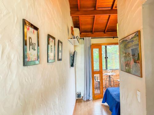 a hallway with pictures on the wall of a house at Ap Encontro dos Sonhos in Carrancas