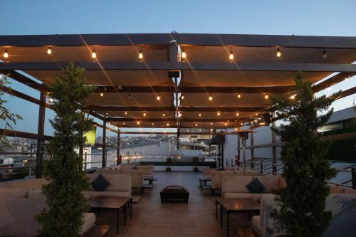 a patio with couches and lights on a building at Hotel Grand One Plaza in Tijuana