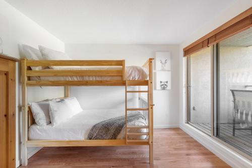 a bedroom with two bunk beds and a window at Gleneagle 29 - Townhome near Golf Course with Balcony, BBQ - Whistler Platinum in Whistler