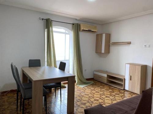 a living room with a table and chairs and a window at Oran in Oran