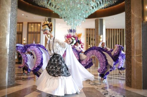 a group of people dancing in a room at Fili Hotel at Nustar Cebu in Cebu City