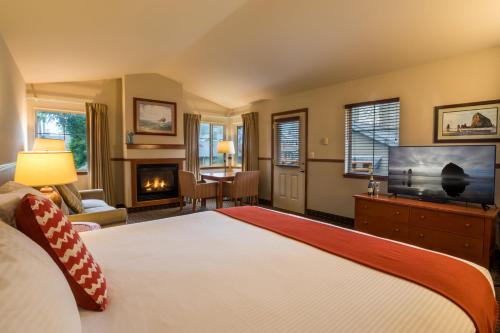 a bedroom with a large bed and a television at Inn at Cannon Beach in Cannon Beach