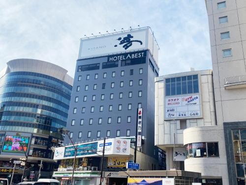 a hotel attack sign on a building in a city at Hotel Abest Nagano Ekimae in Nagano