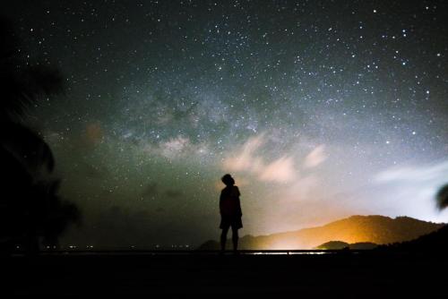 a man standing in front of a starry sky at Ozone Hill Panoramic Residence Thong Nai Pan Beach in Thong Nai Pan Noi