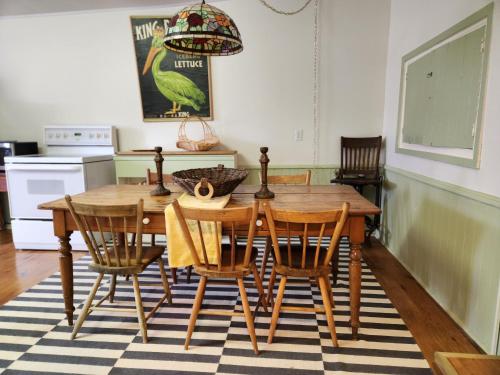 a kitchen with a wooden dining table and chairs at Stone Carriage House in Picton
