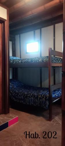 a room with two bunk beds and a window at Villa Tikuna in Mariquita