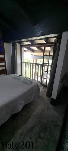 a bedroom with a bed in a room at Villa Tikuna in Mariquita