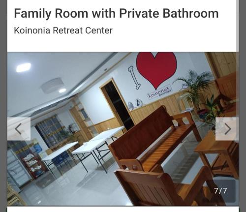 a family room with a table and chairs and a heart on the wall at Koinonia Retreat CenteR in Baguio