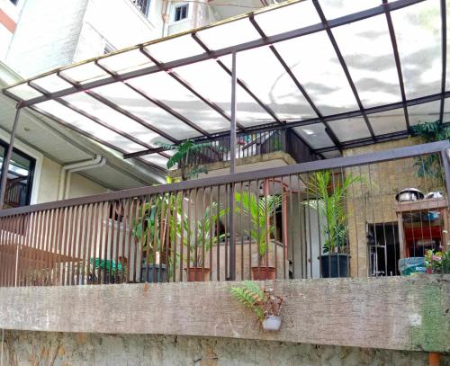 a balcony with plants in pots on a house at Koinonia Retreat CenteR in Baguio