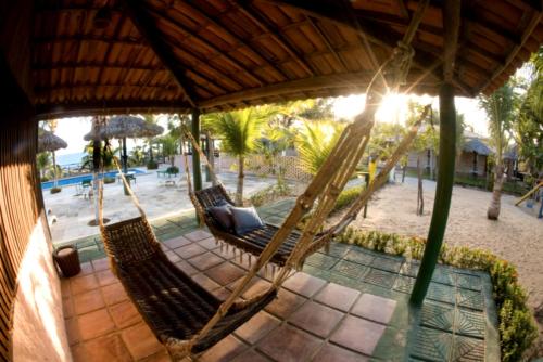 an aerial view of two hammocks on a beach at Pousada Sitio Phoenix in Prea