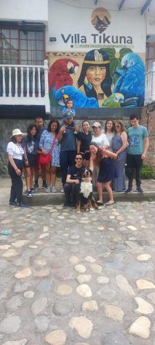 a group of people posing for a picture in front of a building at Villa Tikuna in Mariquita