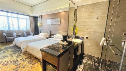a hotel room with two beds and a shower at Ramada Foshan Hotel in Foshan