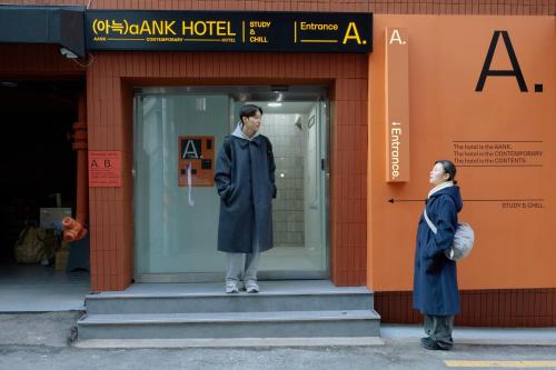 a mannequin stands in the doorway of a building at Aank Hotel Seoul Sinchon in Seoul