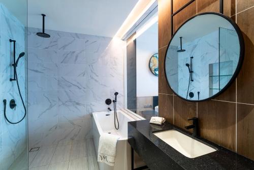 a bathroom with a sink and a mirror at Mercure Kuala Lumpur Trion in Kuala Lumpur
