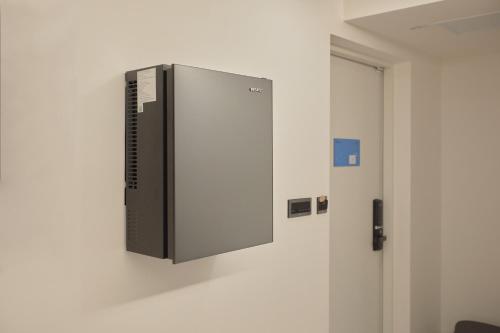 a computer on a wall in a room at Aank Hotel Seoul Sinchon in Seoul