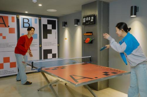 two people playing a game of ping pong at Aank Hotel Seoul Sinchon in Seoul
