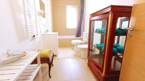 a bathroom with a toilet and a sink at Gardunha Apartments 3º Direito in Fundão