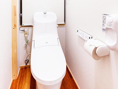 a bathroom with a white toilet in a stall at MOBILITA COURT IWATE in Hachimantai