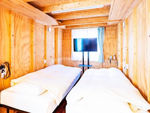 Un pat sau paturi într-o cameră la MOBILITA COURT IWATE