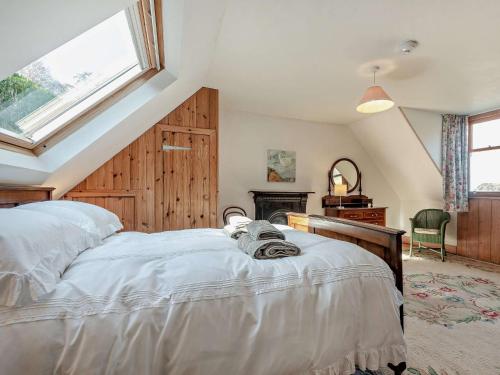 a bedroom with a bed and a window at 2 Bed in Lochranza 77882 in Lochranza