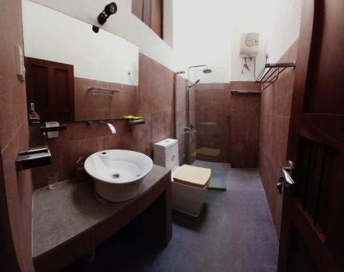 a bathroom with a sink and a toilet at Cosy Secure Comfortable for whole family in Colombo